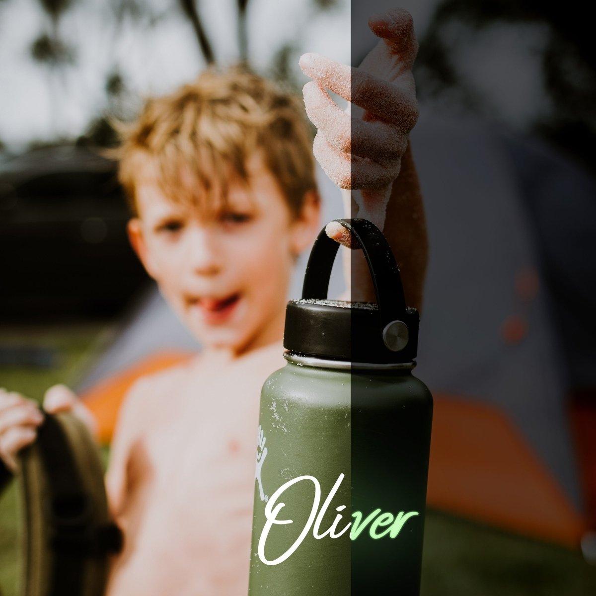 Child holding a green water bottle with a custom glow-in-the-dark name decal saying 'Oliver' in a playful outdoor setting.