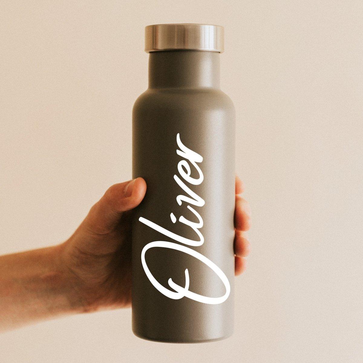 Personalized glow-in-the-dark vinyl name decal on a gray water bottle held by a person.