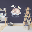 Adorable sleeping bear wall sticker with stars and moon, perfect for kids' room decor and creating a dreamy atmosphere.