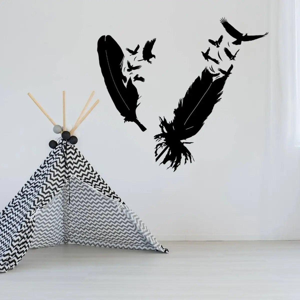 Stylish bird feather wall sticker design in black on a white wall above a geometric play tent.