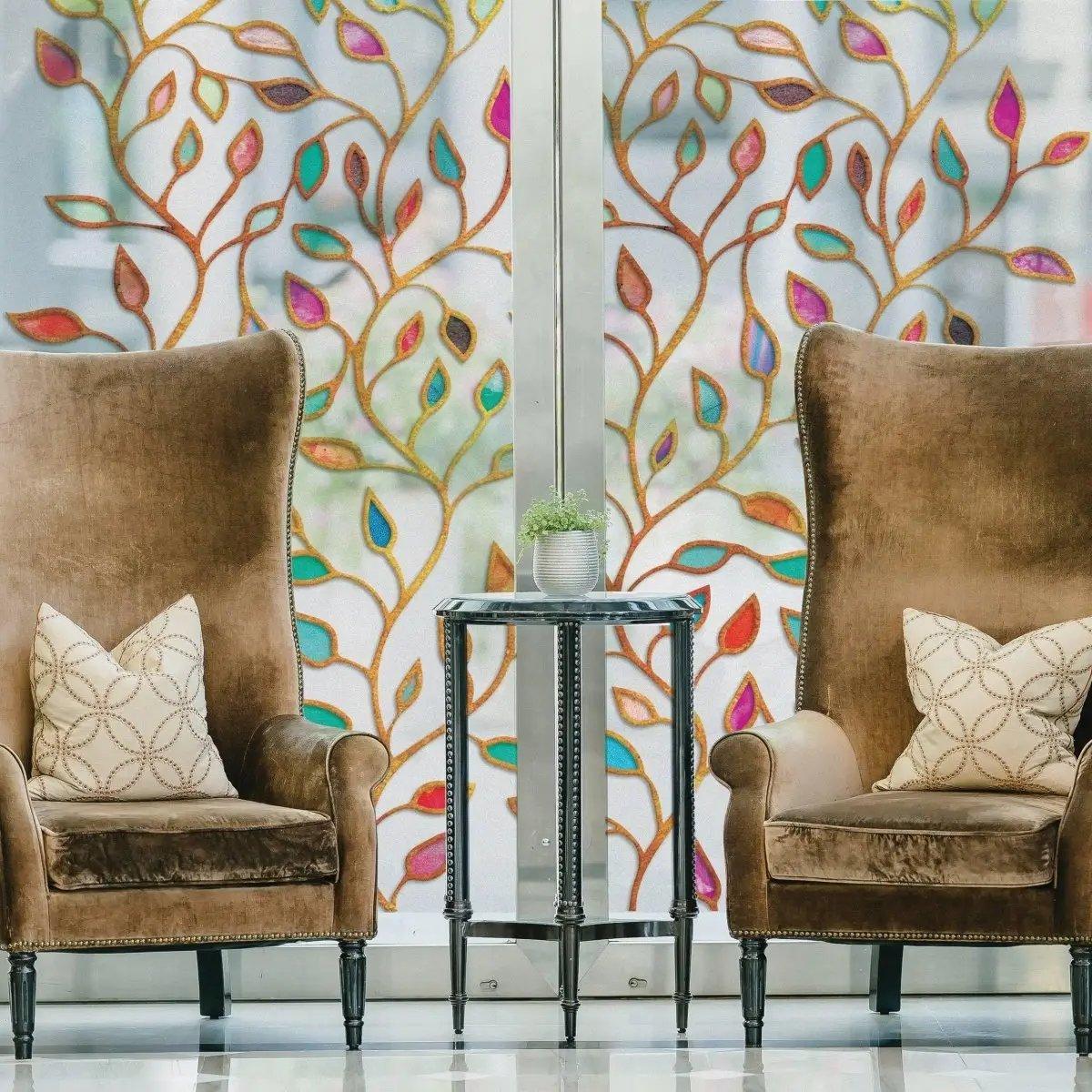 Elegant living room with leaf pattern privacy window film, stylish armchairs, and decorative table.