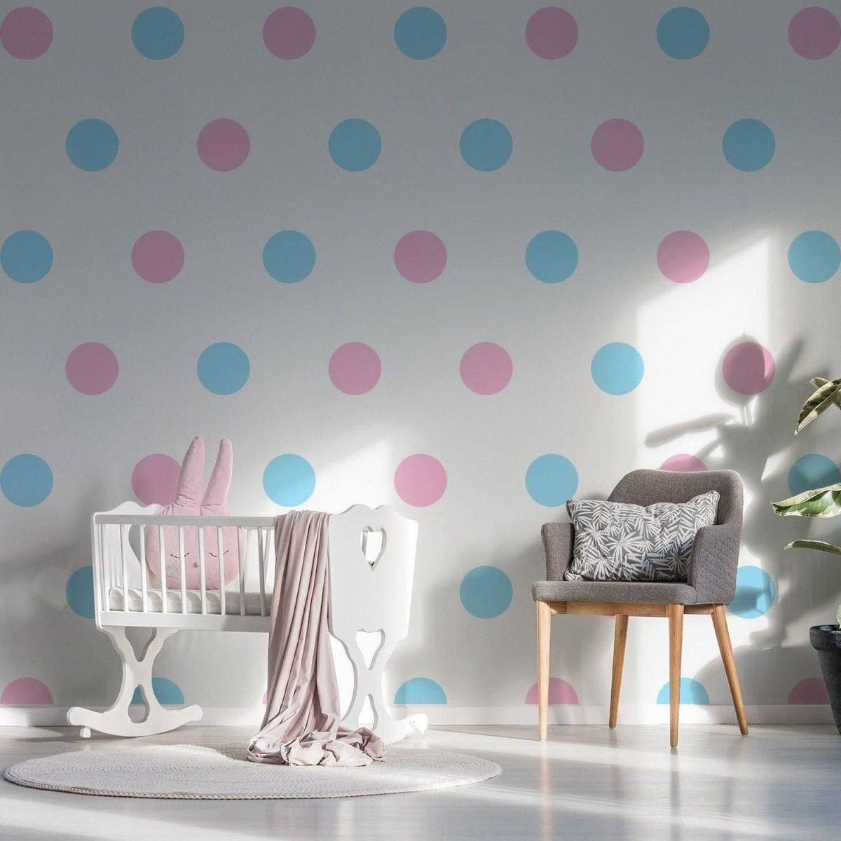 Colorful blue and pink circle wall decals in a cozy nursery with a crib and chair.