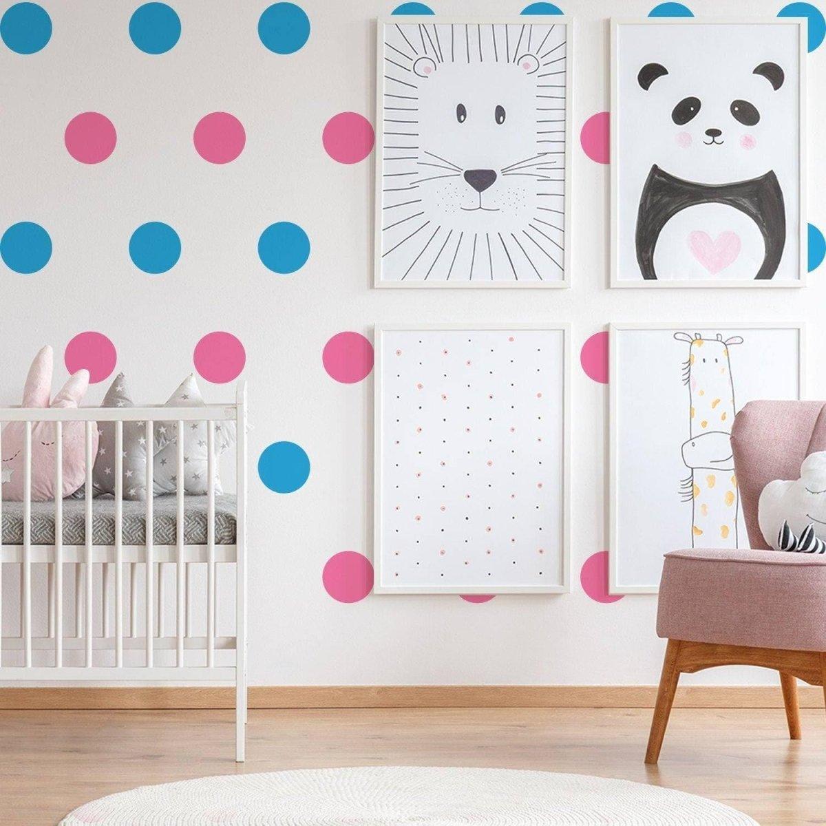 Colorful nursery decor featuring blue and pink polka dot wall stickers paired with playful animal art prints.