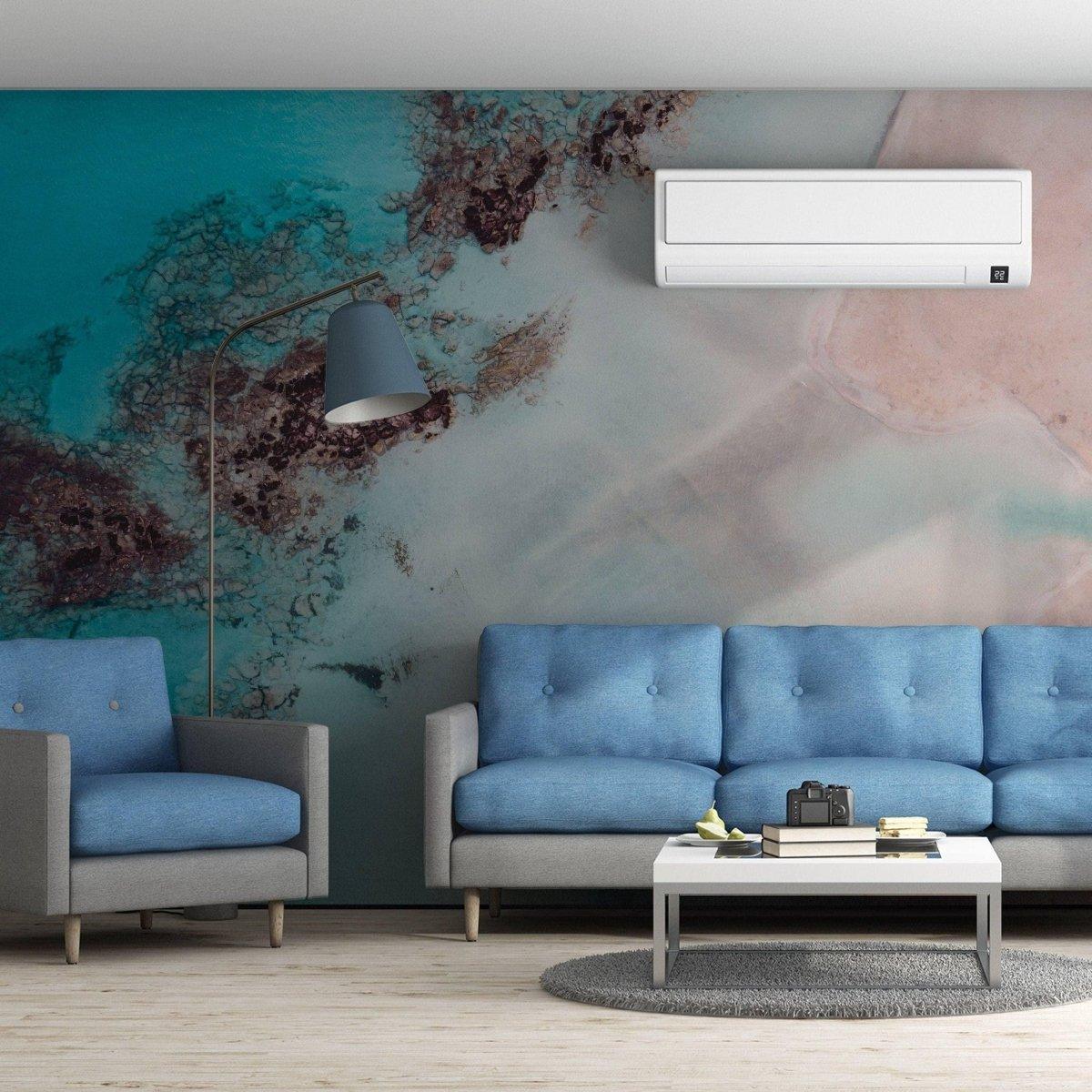 Contemporary living room featuring luxurious marble wall covering with blue sofas and stylish decor.