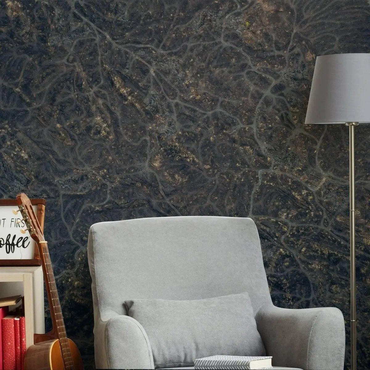 Luxurious marble effect wall covering in a cozy living room setting with a grey chair and modern decor.