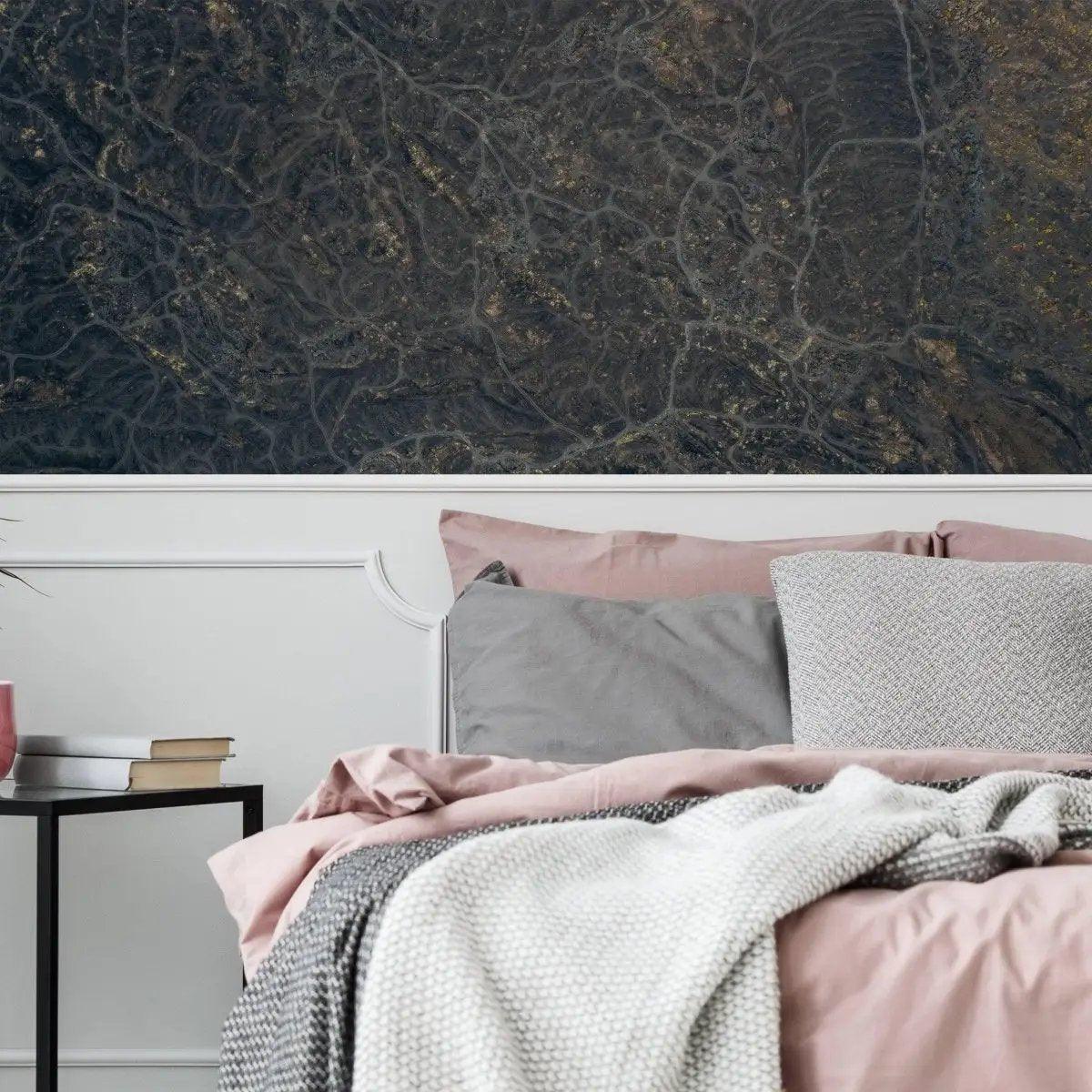 Luxurious marble effect wall covering in a cozy bedroom setting with stylish bedding and contemporary decor.