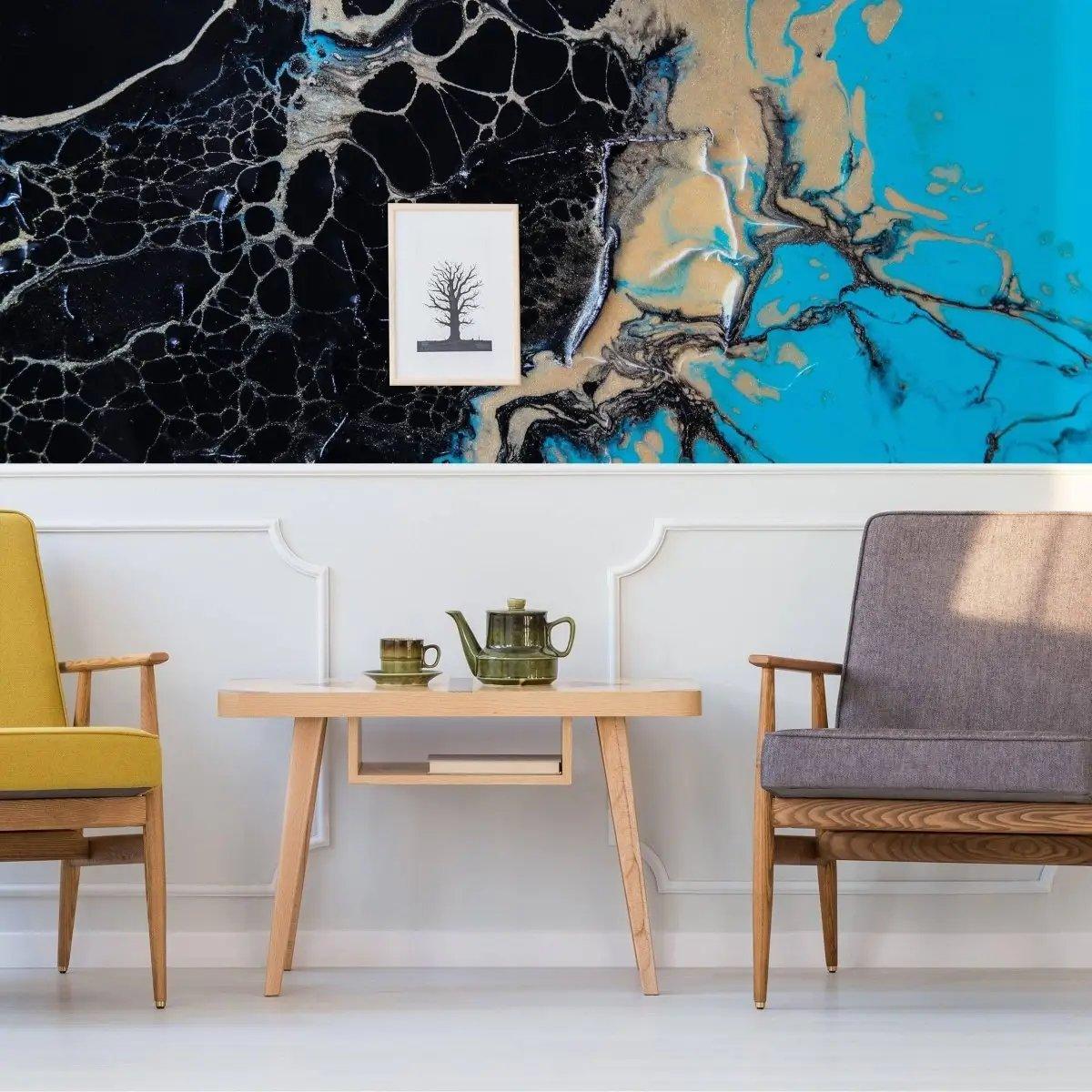 Elegant marble wall covering in a modern living space with yellow and gray chairs and a coffee table.