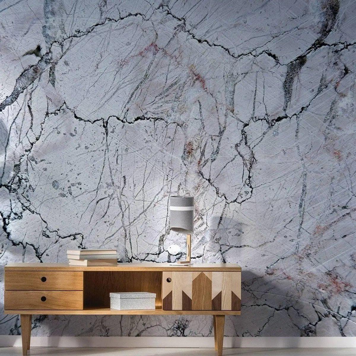 Elegant marble wall covering with a modern wooden cabinet and lamp, showcasing a stylish interior design.