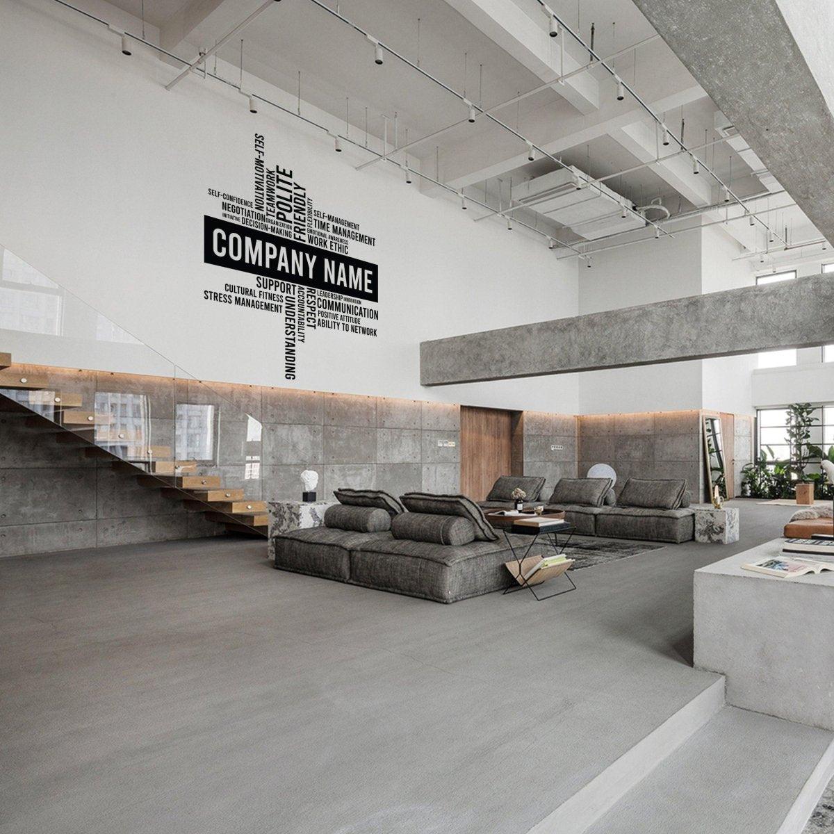 Modern office interior with wall decals promoting company values and a sleek, minimalist design.