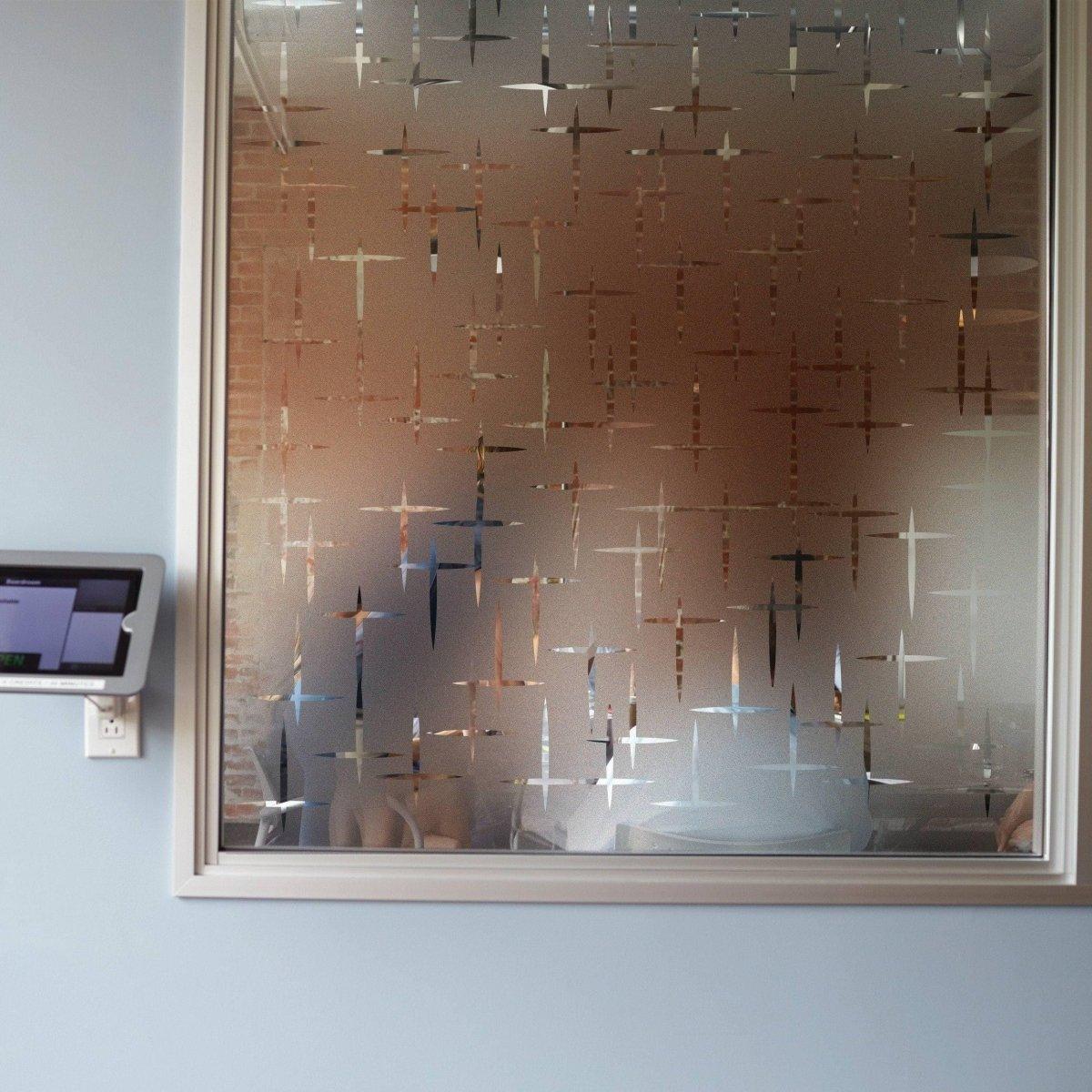 Chic frosted privacy film applied to a glass window, enhancing style while allowing natural light.