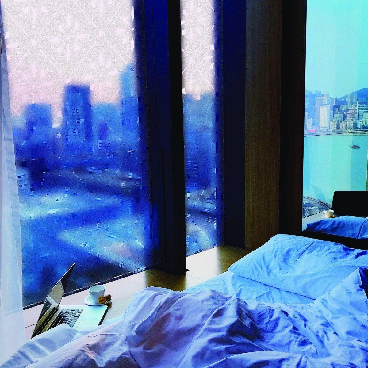 Deluxe geometric frosted window decal in a modern bedroom with city view, enhancing privacy and style.