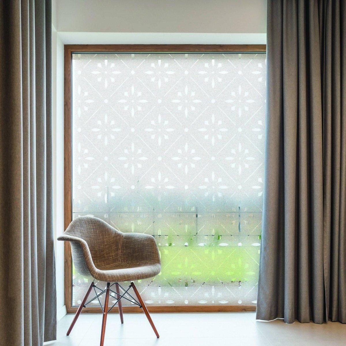 Deluxe geometric frosted window decal providing privacy and style, featuring a modern chair and curtain in a bright room.