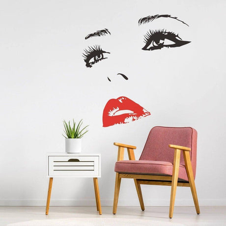 Elegant wall art decal of a woman’s face with red lips, perfect for home decor and adding charm to any space.