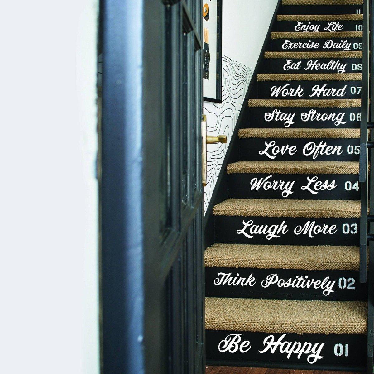 Vinyl stair decals featuring inspirational quotes on black stair risers, enhancing home decor.