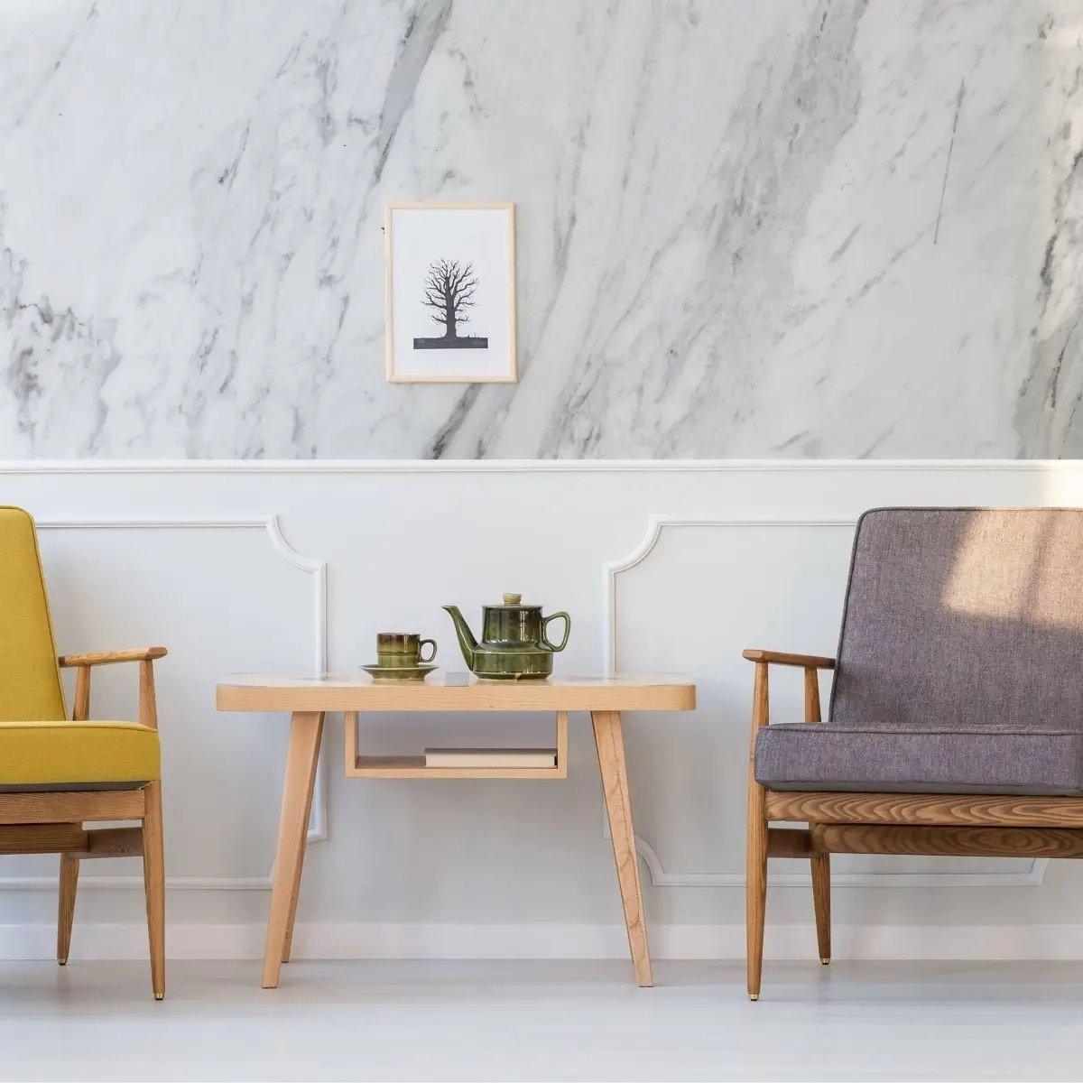Stylish living room featuring marble-pattern wallpaper, wooden table, and modern chairs with a cozy decor.