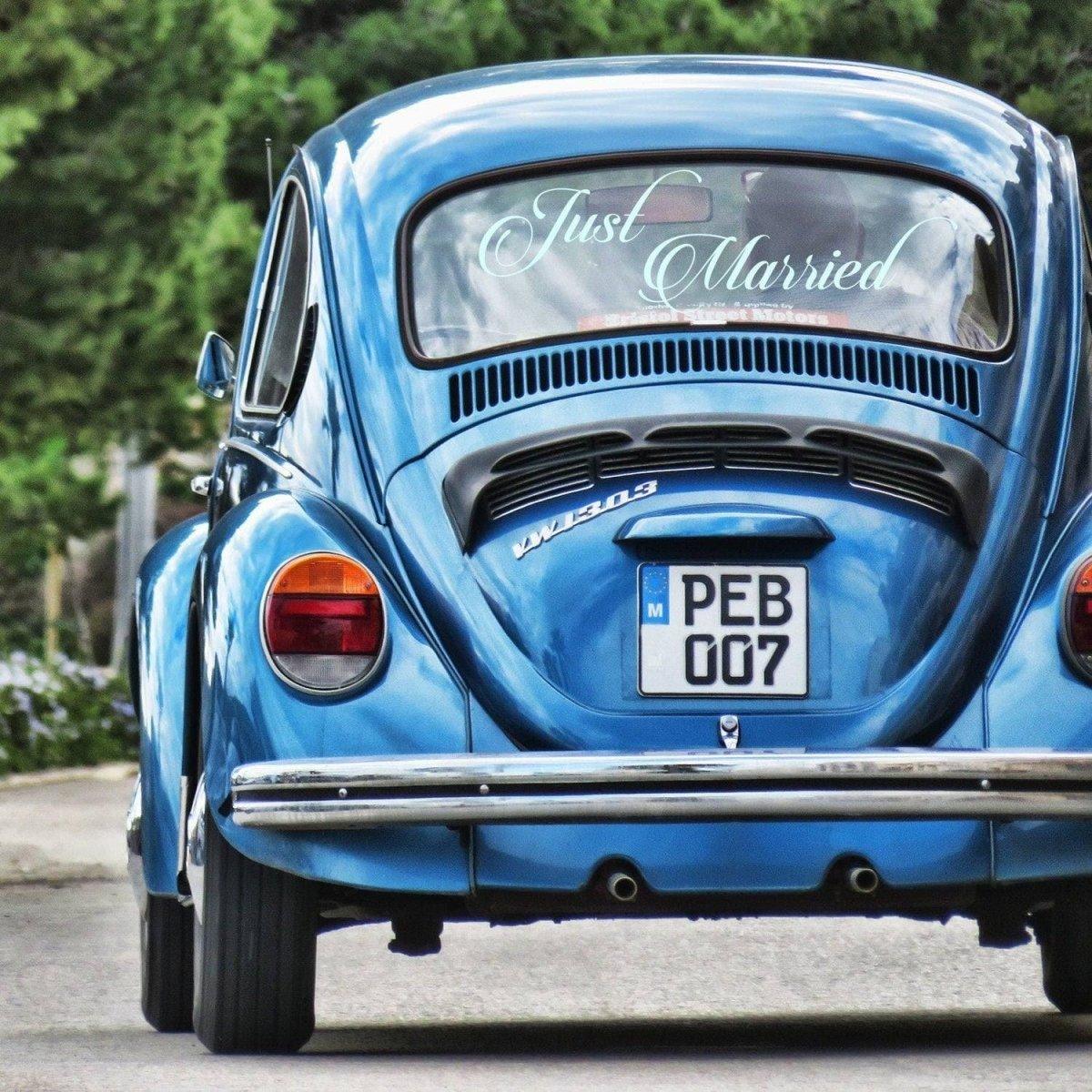 Blue car with 'Just Married' sticker, perfect for wedding day car decoration, showcasing blissful celebration.