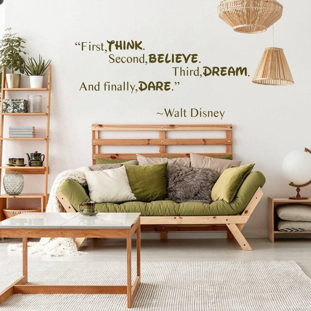 Vinyl wall sticker with Walt Disney quote in a cozy living room setting, featuring lush green pillows and natural decor.