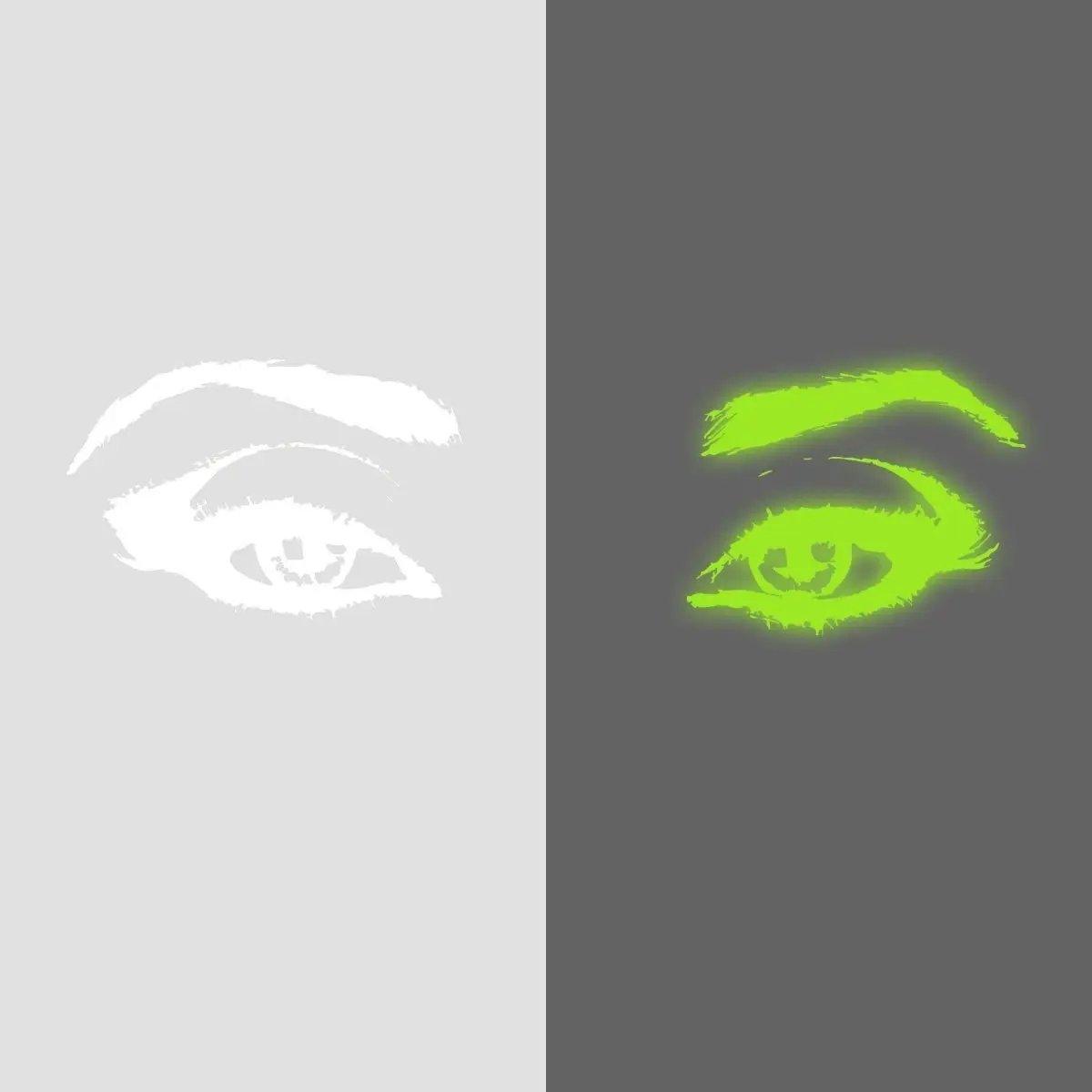 Glowing luminescent eye vinyl wall decal in bright green and white on contrasting backgrounds.