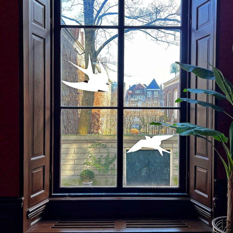 FeatherGuard anti-collision bird decals displayed on a window, enhancing bird safety while maintaining home aesthetics.