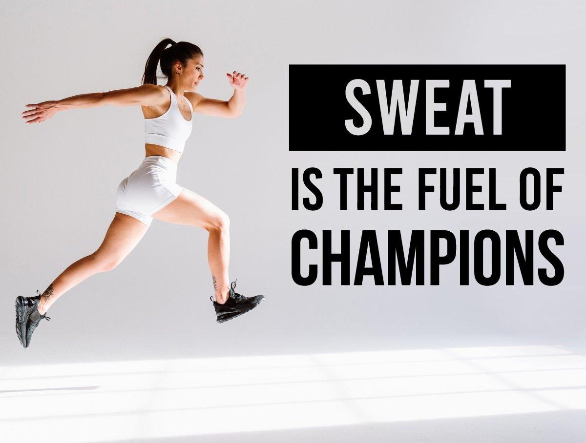 Fitness wall decal with motivational quote 'Sweat is the fuel of champions' on a background of a woman jumping.