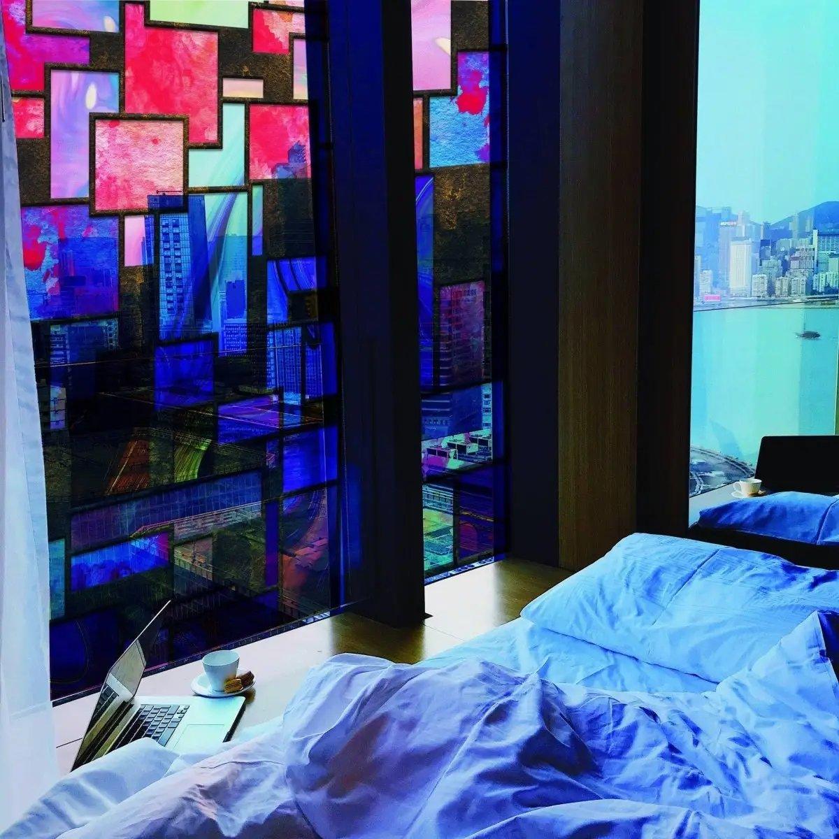 Frosted window film offering privacy and elegance in a modern bedroom with city views.
