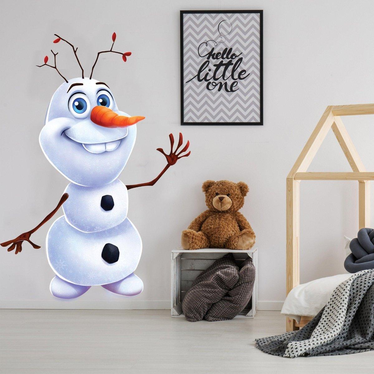 Large vinyl wall sticker of a smiling snowman in a cozy room with a teddy bear and patterned wall decor.