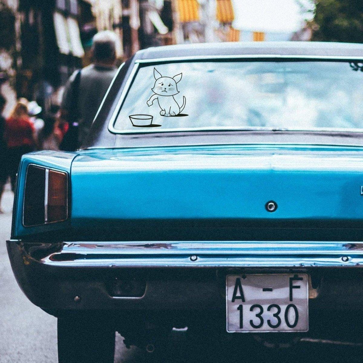 Cute cat vinyl sticker on a blue car, adding personality to the vehicle's rear window.