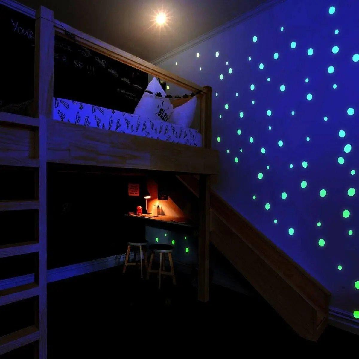 Cozy bedroom with glow in the dark circle wall decals, creating a starry sky effect on the walls.