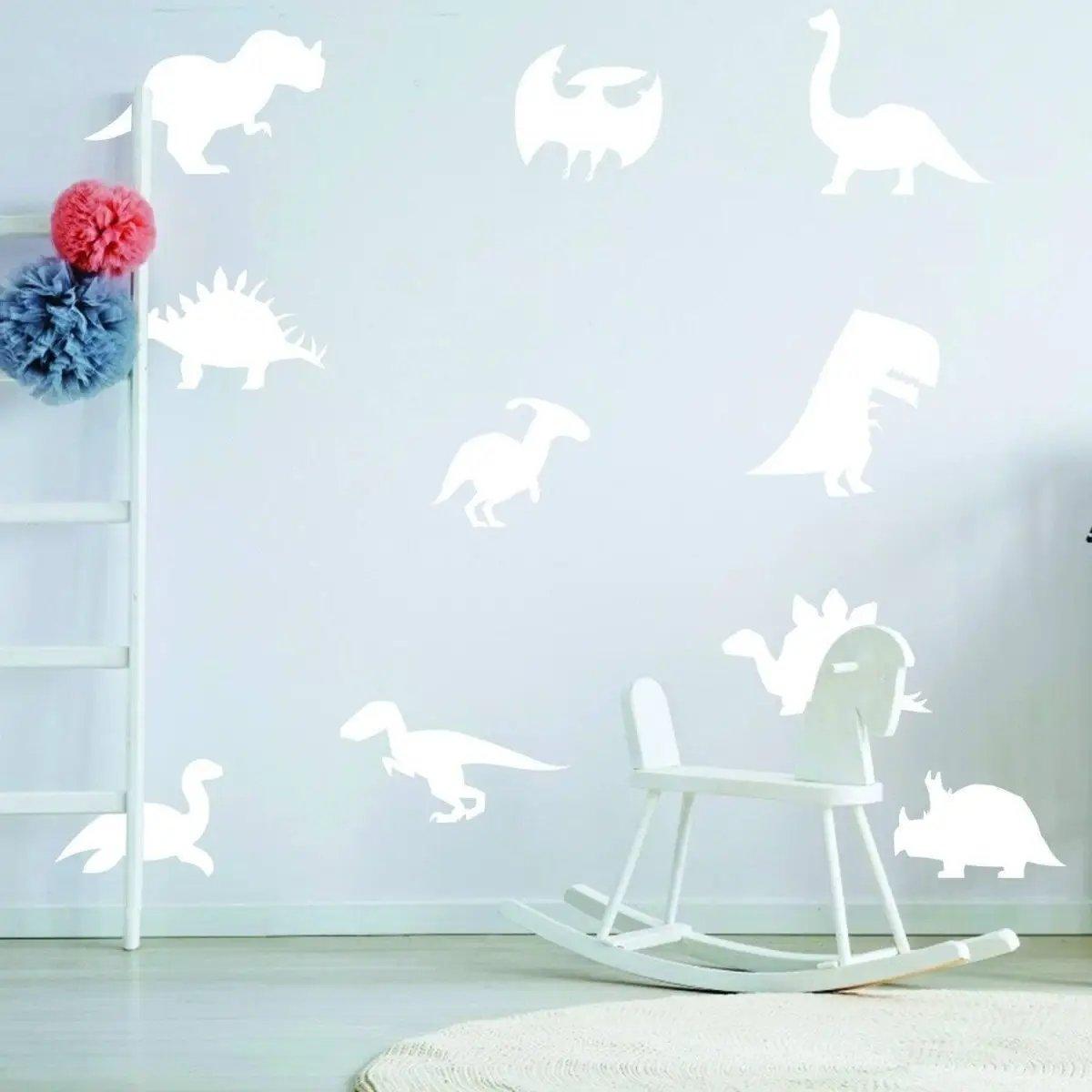 Glow-in-the-dark dinosaur wall decals in a children's room, featuring various cute dinosaur silhouettes.