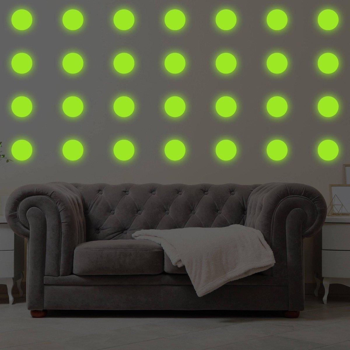 Illuminated wall with glow in dark dots above a cozy gray couch, enhancing galaxy decor theme.