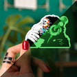Glow in the dark monkey vinyl laptop decal featuring colorful headphones, perfect for fun surfaces.