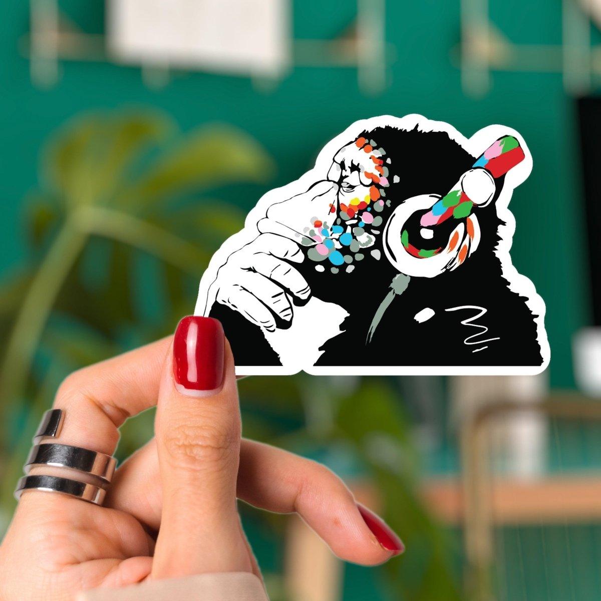 Colorful monkey vinyl decal with headphones, perfect for adding fun to laptops or surfaces.