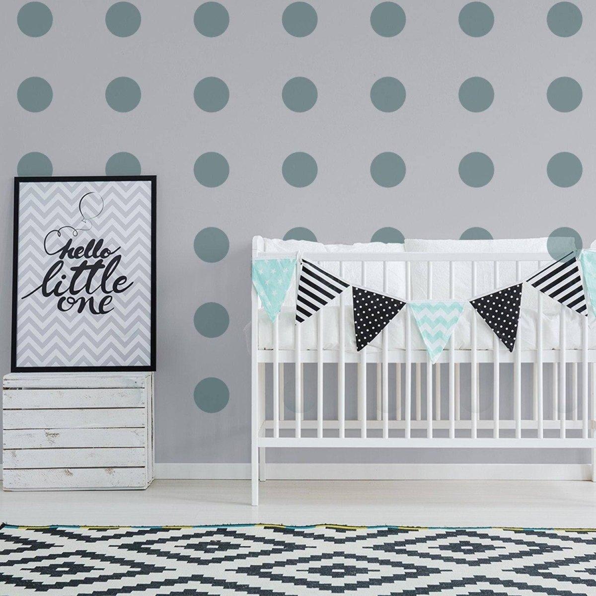 Nursery with gold circle wall decals, crib, and decorative bunting for a magical touch.
