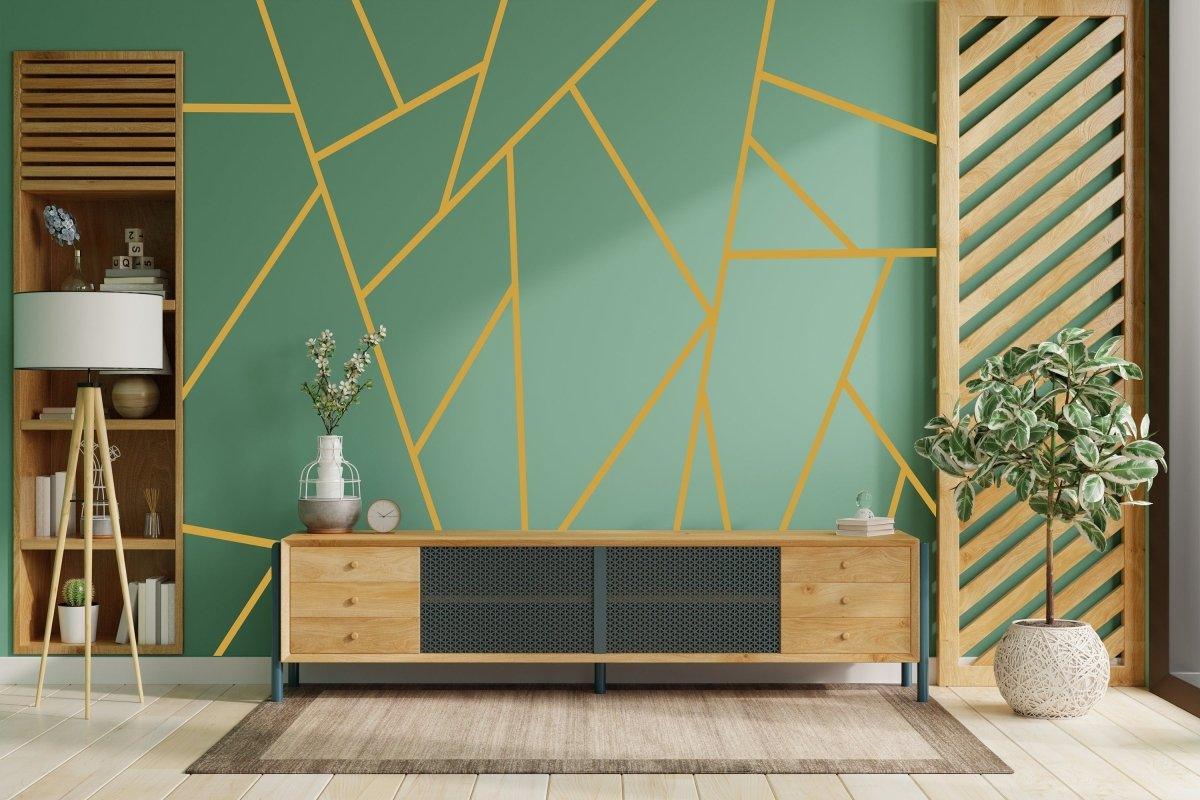 Modern living room with green wall featuring geometric gold wall stickers and stylish wooden furniture.