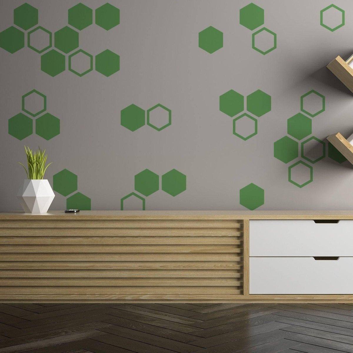 Green hexagon wall decals arranged on a grey wall, enhancing living room aesthetics with elegance.