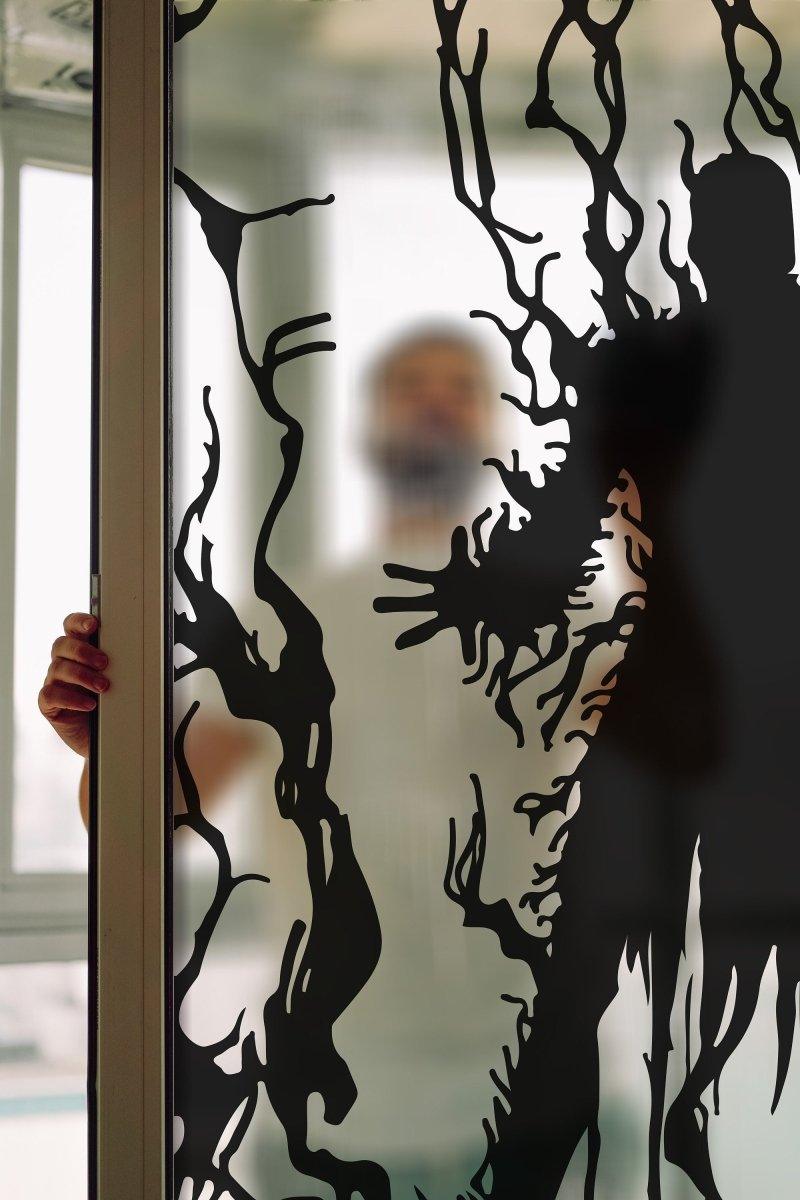 Frosted vampire silhouette window decal adding gothic allure and privacy, featuring intricate dark designs.
