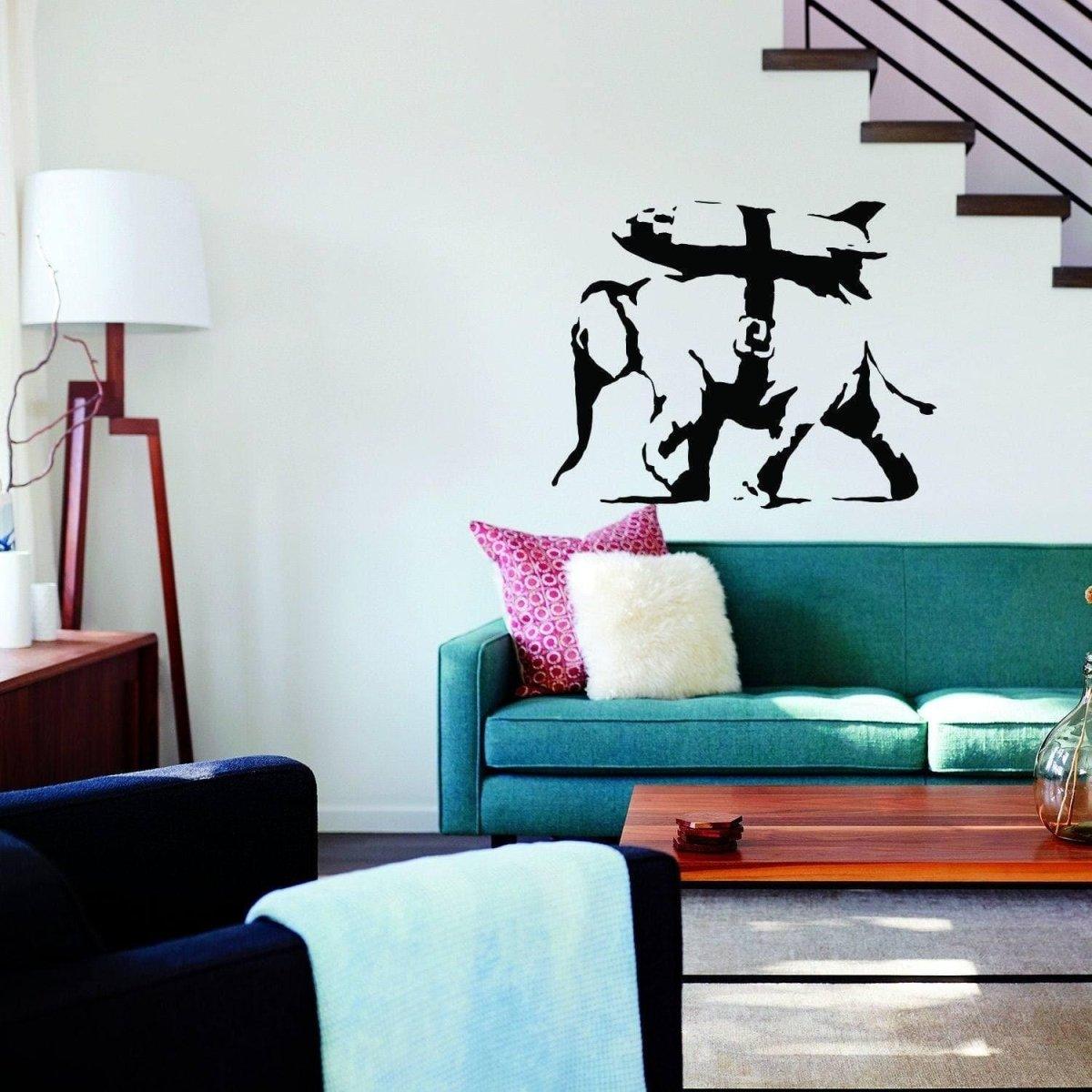 Majestic elephant graffiti style vinyl sticker on a living room wall above a green couch, vibrant wall art decor.