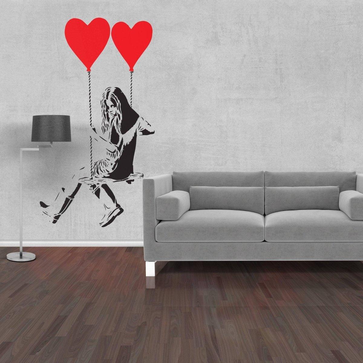 Banksy-inspired girl wall sticker with red heart balloons in modern living room decor.