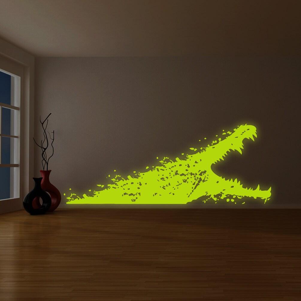 Glowing vinyl wall decal of a dragon design on a living room wall, adding a unique and creative touch to the space.