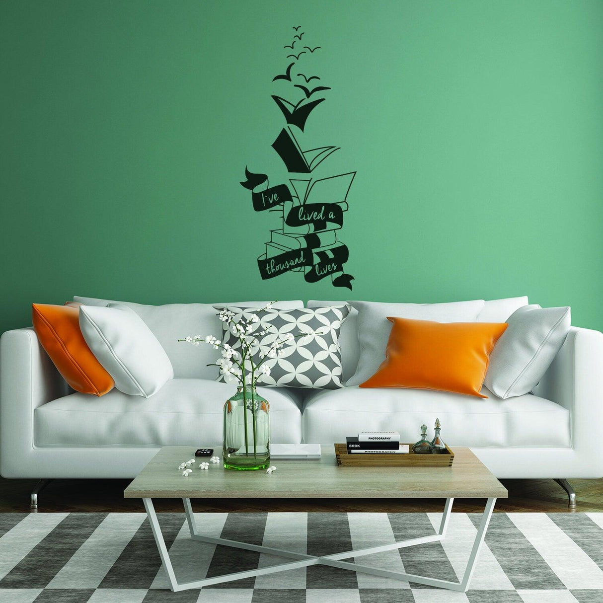 Motivational wall decal quote on green wall above stylish sofa with books and birds design.