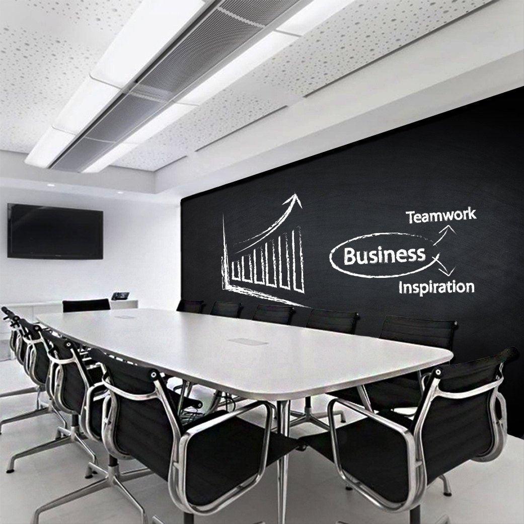Modern conference room with a chalkboard wall displaying business growth, teamwork, and inspiration concepts.