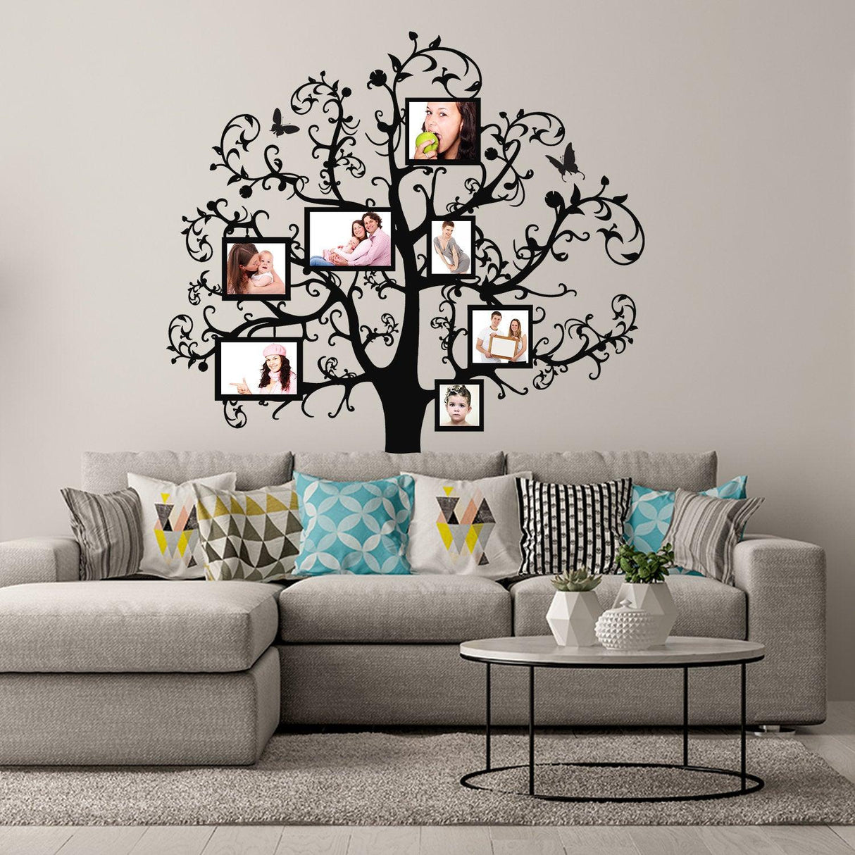 Family vinyl wall decal featuring a tree design for displaying photos above a modern couch and decorative pillows.
