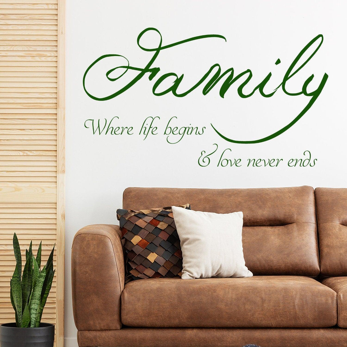 Family quote wall sticker with the words 'Where life begins & love never ends' above a cozy couch.