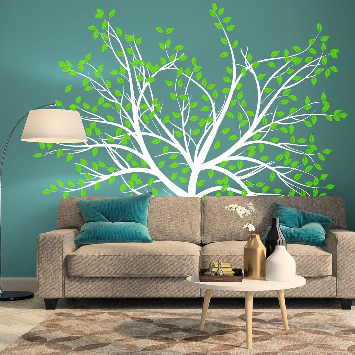 Birch tree wall decal in a living room above a beige couch with green leaves and teal accents.