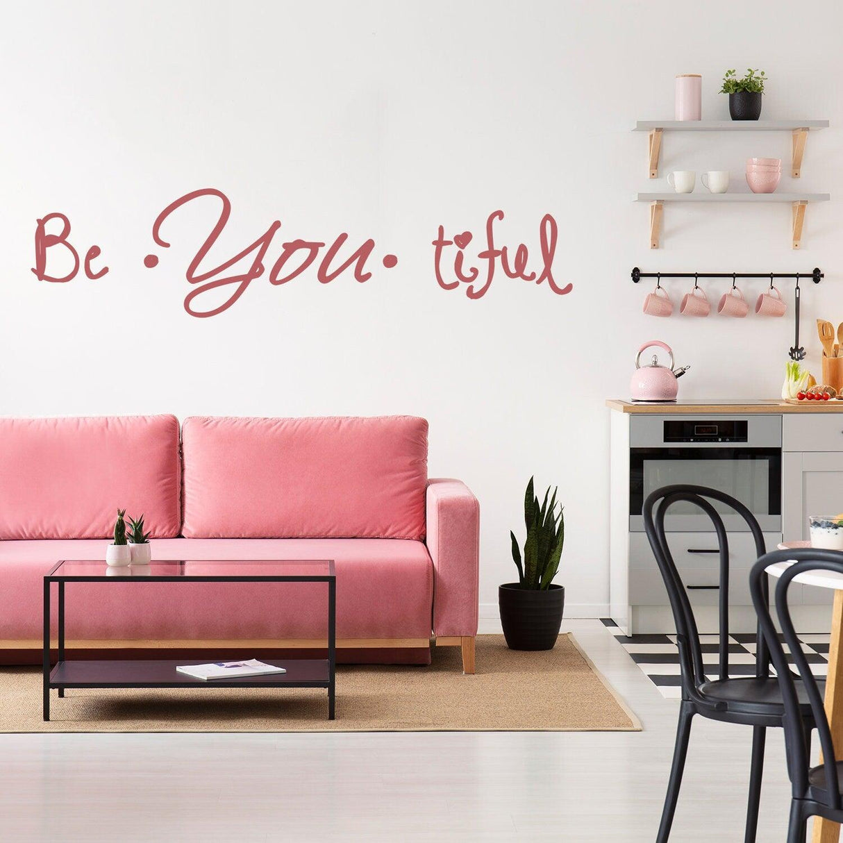 Beautiful quote wall sticker 'Be You tiful' displayed over a pink sofa in a stylish kitchen setting.