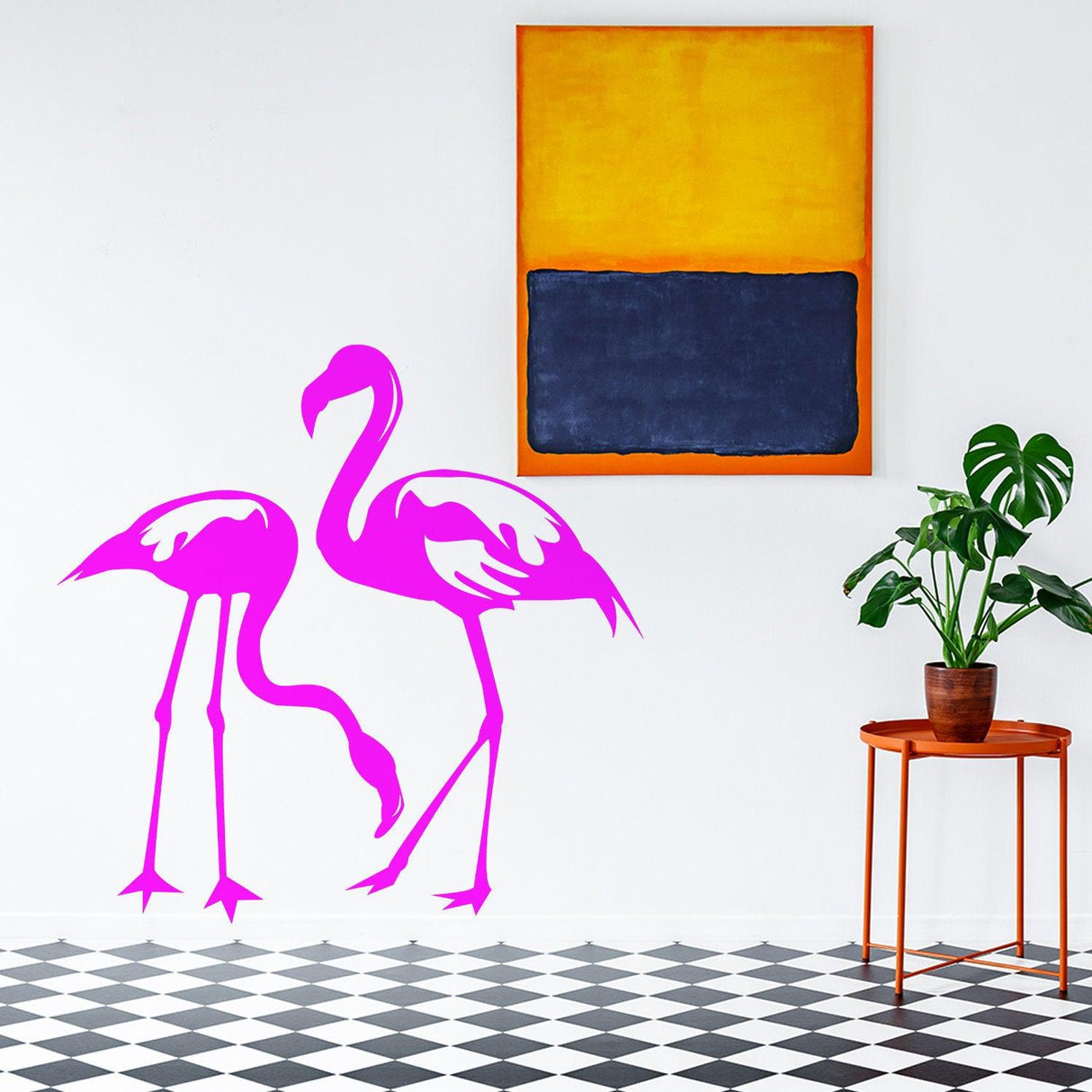 Two pink flamingo decals on a white wall, with colorful modern art and a potted plant for tropical decor.
