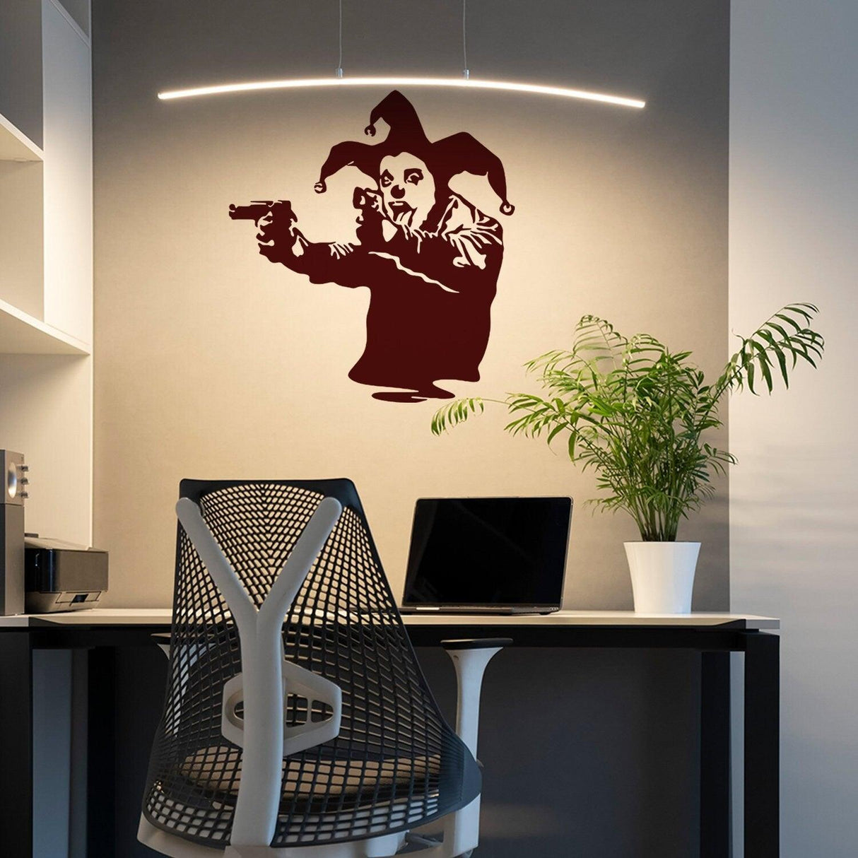 Banksy vinyl wall decal of a joker clown with guns, stylish street art decor for modern interiors.