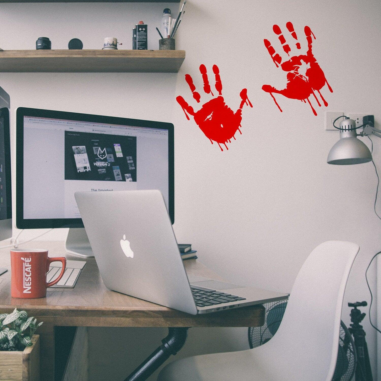 Bloody hands scary red vinyl sticker on a desk, perfect for Halloween decor or horror themes.