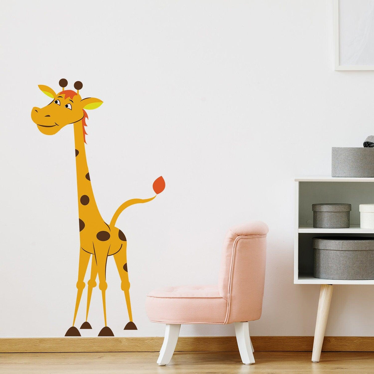 Nursery Giraffe Vinyl Wall Sticker in a child's room next to a pink chair, adding cute animal decor.