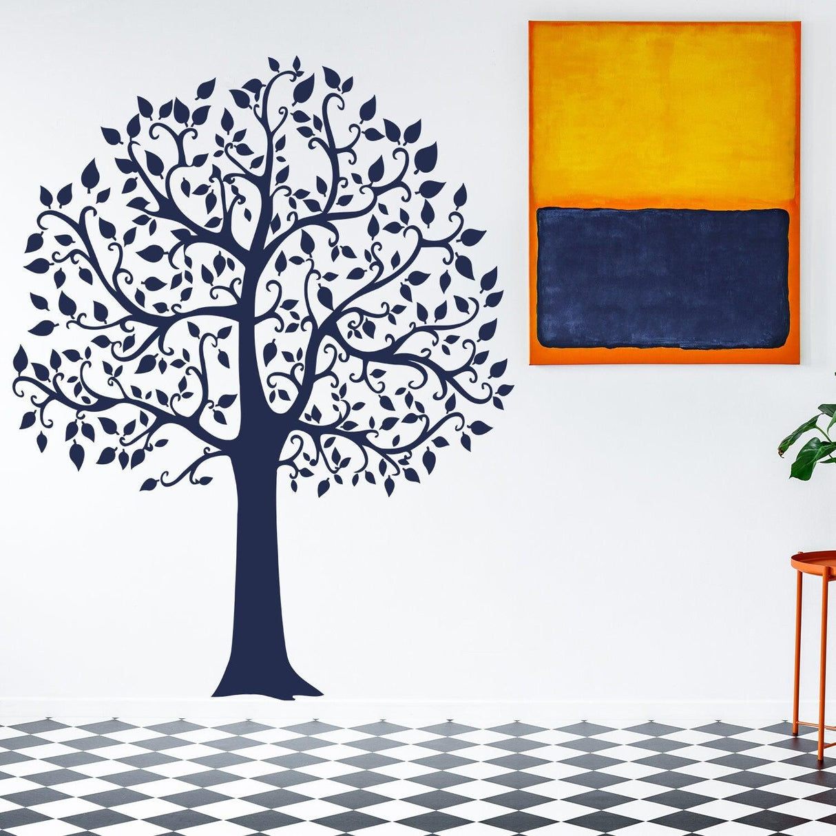 Tree sticker decal on a wall with artwork above, adding nature-inspired decor to a room.